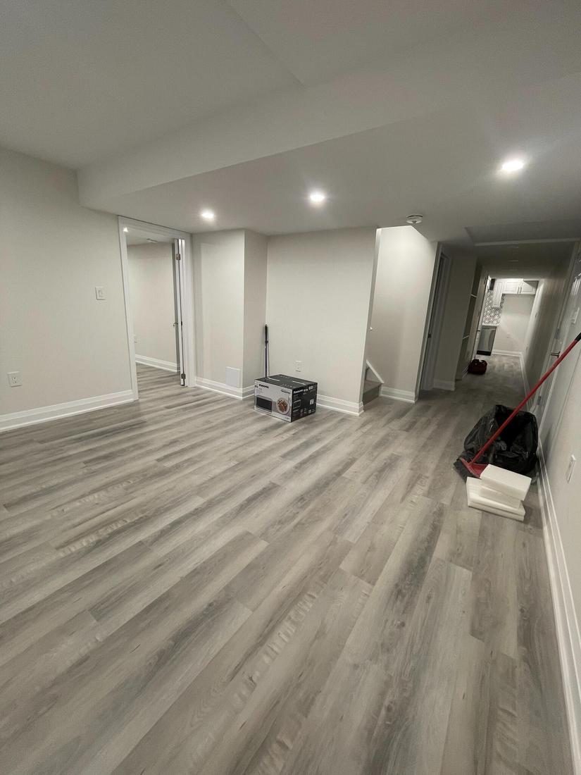 Finished basement with new flooring, pot lights, and smooth drywall — clean, bright, and move-in ready.