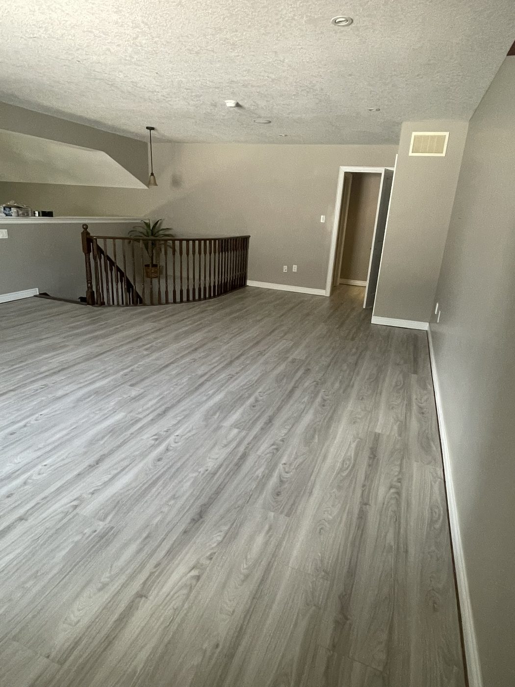 Wide-plank wood-look flooring installed across an open-concept living space.